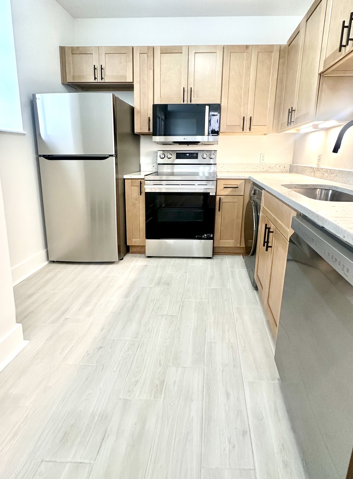 Kitchen showing LG refrigerator, range and dishwasher